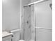 Modern bathroom with marble-style tiled shower, new fixtures, and a sleek glass door at 1011 Indian Oaks W, Daytona Beach, FL 32117