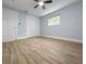 Bright bedroom with new wood-look floors, closet, a ceiling fan, and a window for natural light at 1011 Indian Oaks W, Daytona Beach, FL 32117