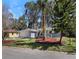 Well maintained front yard with lush landscaping, a long driveway, and an attached garage at 1011 Indian Oaks W, Daytona Beach, FL 32117