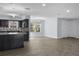 Open floor plan with kitchen featuring granite counters, stainless appliances, and modern lighting at 1011 Indian Oaks W, Daytona Beach, FL 32117
