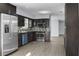 Modern kitchen boasts stainless steel appliances, dark cabinets, and a stylish backsplash at 1011 Indian Oaks W, Daytona Beach, FL 32117