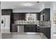 Contemporary kitchen featuring stainless steel appliances, dark cabinetry, and sleek countertops at 1011 Indian Oaks W, Daytona Beach, FL 32117