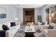 Comfortable living room with a brick fireplace, modern furnishings, and abundant natural light at 1011 Indian Oaks W, Daytona Beach, FL 32117