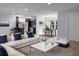 Spacious open-concept living area with sleek flooring, modern decor, and seamless kitchen access at 1011 Indian Oaks W, Daytona Beach, FL 32117
