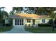 Charming single-story home with a neutral color, well-manicured lawn, and a screened in garage at 10891 Sw 86Th Ave, Ocala, FL 34481