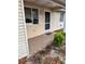 Inviting front porch with neutral siding and a 'For Sale' sign in the window at 10891 Sw 86Th Ave, Ocala, FL 34481