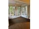 The sunroom features large windows offering natural light and views, plus a ceiling fan and carpeted floor at 10891 Sw 86Th Ave, Ocala, FL 34481