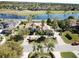 Stunning aerial shot of a single-story home with a terracotta roof, a lake view, and lush landscaping at 1317 Dovercourt Ln, Ormond Beach, FL 32174