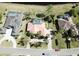 Birds-eye view of single-story home, featuring a terracotta roof, enclosed pool, manicured greenery, and serene neighborhood at 1317 Dovercourt Ln, Ormond Beach, FL 32174