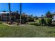 Spacious backyard with lush lawn, mature trees, and an enclosed pool area for outdoor enjoyment at 1317 Dovercourt Ln, Ormond Beach, FL 32174
