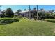 Expansive backyard with lush green lawn, screened enclosure, and mature landscaping at 1317 Dovercourt Ln, Ormond Beach, FL 32174