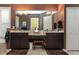 Bathroom featuring a dual sink vanity, large mirror, and an adjacent door for added accessibility at 1317 Dovercourt Ln, Ormond Beach, FL 32174