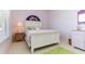 Bright bedroom with a bed, bedside table, and a window at 1317 Dovercourt Ln, Ormond Beach, FL 32174