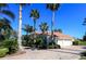 Beautiful single-story home with tile roof, mature landscaping, and a circular driveway at 1317 Dovercourt Ln, Ormond Beach, FL 32174