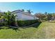 Well-maintained home exterior with lush green lawn and mature hedges under a bright blue sky at 1317 Dovercourt Ln, Ormond Beach, FL 32174