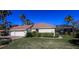 Charming home featuring a well-manicured lawn, red tile roof, and a spacious three-car garage at 1317 Dovercourt Ln, Ormond Beach, FL 32174