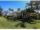 Attractive landscaping surrounding the home's exterior, complemented by lush green grass and mature palm trees at 1317 Dovercourt Ln, Ormond Beach, FL 32174