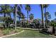 Elegant single-story home with meticulously maintained landscaping, mature palms and lush green lawn at 1317 Dovercourt Ln, Ormond Beach, FL 32174