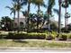 Charming home with mature palm trees, verdant landscaping, and a well-manicured lawn, creating an inviting curb appeal at 1317 Dovercourt Ln, Ormond Beach, FL 32174