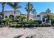 Beautiful home with lush landscaping and a paver driveway, nestled among mature palm trees on a sunny day at 1317 Dovercourt Ln, Ormond Beach, FL 32174