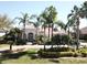 Inviting home with a paver driveway, lush landscaping, and mature palm trees, creating an appealing exterior at 1317 Dovercourt Ln, Ormond Beach, FL 32174