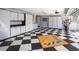 Large garage features checkered floors, storage cabinets and wall decor at 1317 Dovercourt Ln, Ormond Beach, FL 32174