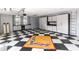 Spacious garage with checkered flooring, white cabinets, and natural light from windows at 1317 Dovercourt Ln, Ormond Beach, FL 32174
