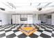 Spacious garage with black and white checkered flooring and custom storage cabinets at 1317 Dovercourt Ln, Ormond Beach, FL 32174