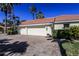 Spacious three-car garage with a paved driveway and manicured landscaping at 1317 Dovercourt Ln, Ormond Beach, FL 32174