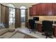 Elegant home office with built-in shelving, ample workspace, and large windows providing abundant natural light at 1317 Dovercourt Ln, Ormond Beach, FL 32174