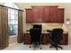 Well-lit home office with large windows, built-in cabinetry, and dual workstations perfect for remote work at 1317 Dovercourt Ln, Ormond Beach, FL 32174