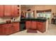 Charming kitchen featuring wood cabinets, granite counters, and stainless steel appliances and sunlit breakfast nook at 1317 Dovercourt Ln, Ormond Beach, FL 32174