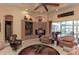 Bright living room featuring neutral walls, tile flooring, coffered ceilings, and a seamless transition to the outdoor pool area at 1317 Dovercourt Ln, Ormond Beach, FL 32174