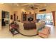 Comfortable living room featuring neutral walls, tile flooring, coffered ceilings, and backyard views at 1317 Dovercourt Ln, Ormond Beach, FL 32174