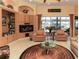 Cozy living room featuring neutral walls, tile flooring, coffered ceilings, and views of the outdoor pool area at 1317 Dovercourt Ln, Ormond Beach, FL 32174