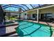 Beautiful pool and jacuzzi with screened enclosure, surrounded by brick pavers and lush greenery at 1317 Dovercourt Ln, Ormond Beach, FL 32174