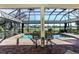 Inviting pool area with a screened enclosure and two chairs at 1317 Dovercourt Ln, Ormond Beach, FL 32174