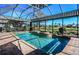 Beautiful screened-in pool with brick pavers and a spa, perfect for relaxation and outdoor enjoyment at 1317 Dovercourt Ln, Ormond Beach, FL 32174