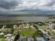 Expansive aerial view of a residential neighborhood near a wide lake at 14 Sea Swallow Ter, Ormond Beach, FL 32176