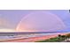 Picturesque beach with rainbow at sunset on waterfront condo property at 14 Sea Swallow Ter, Ormond Beach, FL 32176