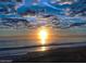 Expansive beachfront view highlighting a tranquil ocean at sunset at 14 Sea Swallow Ter, Ormond Beach, FL 32176