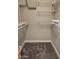 Walk-in closet featuring a carpeted floor and adjustable shelving system for storage at 14 Sea Swallow Ter, Ormond Beach, FL 32176
