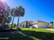 Inviting single-story home with a manicured lawn, palm trees, and attached two-car garage at 14 Sea Swallow Ter, Ormond Beach, FL 32176