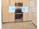 Kitchen area showcasing white cabinets, tiled backsplash, and stainless steel appliances at 14 Sea Swallow Ter, Ormond Beach, FL 32176