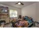 Comfortable bedroom featuring a window with blinds, and unique decor that enhances the room's cozy and inviting ambiance at 1601 Big Tree Rd # 601, South Daytona, FL 32119