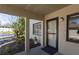 Inviting condo entrance featuring a well-lit doorway, small front garden, and views of the community's pond and landscaping at 1601 Big Tree Rd # 601, South Daytona, FL 32119