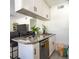 Cozy kitchen with granite countertops, white cabinetry, and stainless steel dishwasher, adjacent to a comfortable seating area at 1601 Big Tree Rd # 601, South Daytona, FL 32119