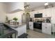 Modern kitchen featuring granite countertops, stainless steel appliances, white cabinets, and a convenient breakfast bar at 1601 Big Tree Rd # 601, South Daytona, FL 32119