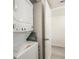 Laundry area featuring a stacked washer and dryer and some storage area at 1601 Big Tree Rd # 601, South Daytona, FL 32119