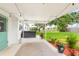 Covered back porch featuring hot tub, string lights, landscaping and access to the yard at 168 Boynton Blvd, Daytona Beach, FL 32118